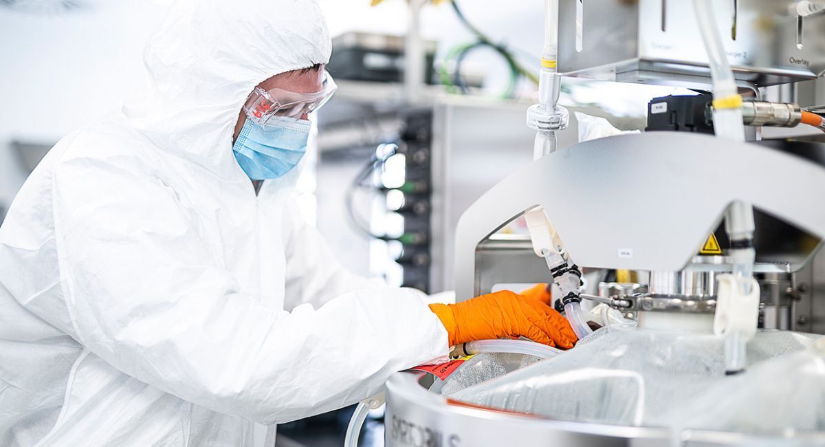Scientist monitoring a bioreactor during biopharmaceutical GMP manufacturing.